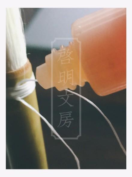 Hold the brush upright (brush head pointing up) and apply 502 super glue over the wrapped thread.