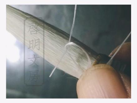 After wrapping, thread the end through the loop you made earlier.